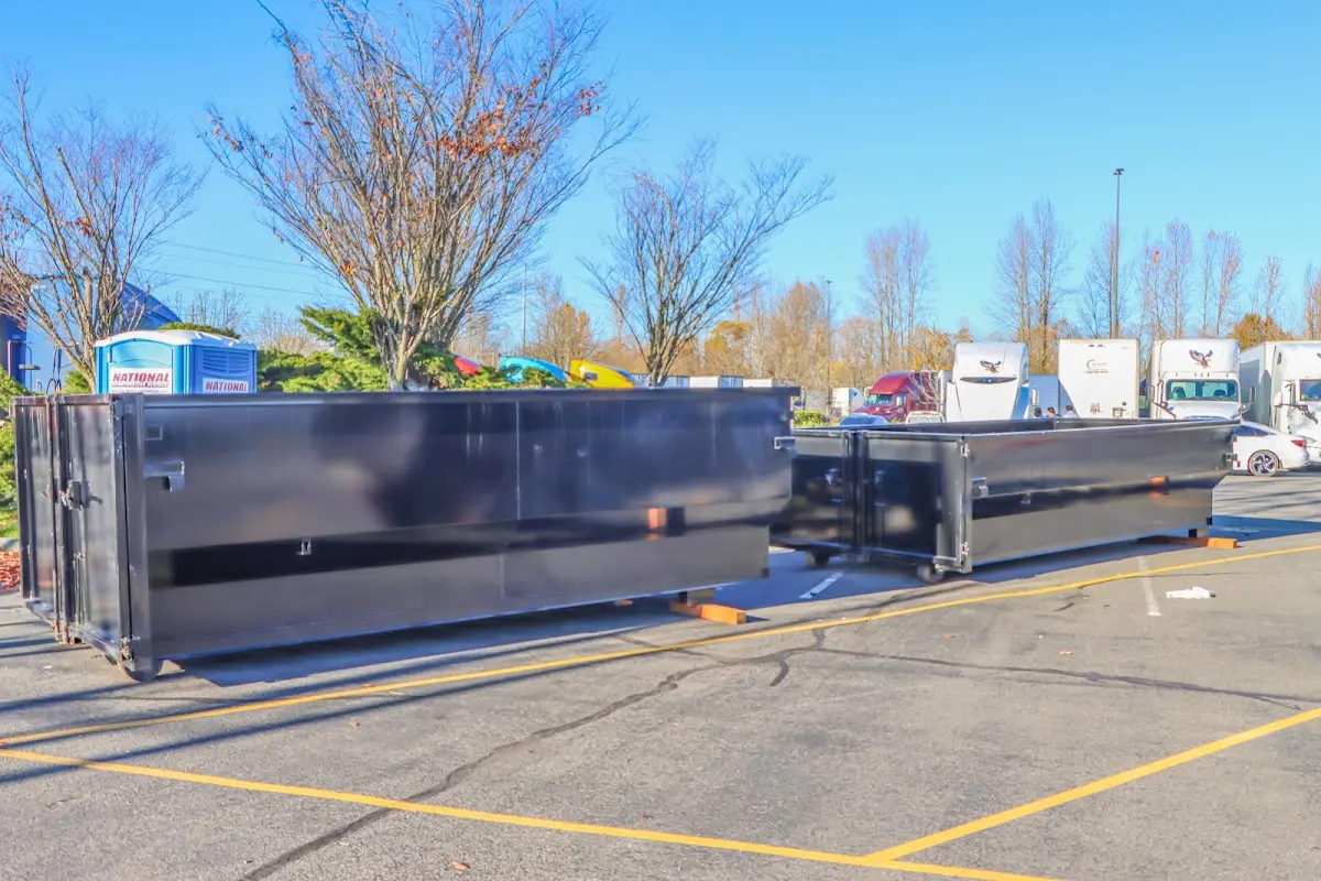 Professional dumpster rental service with roll-off container on residential driveway in Fort Scott